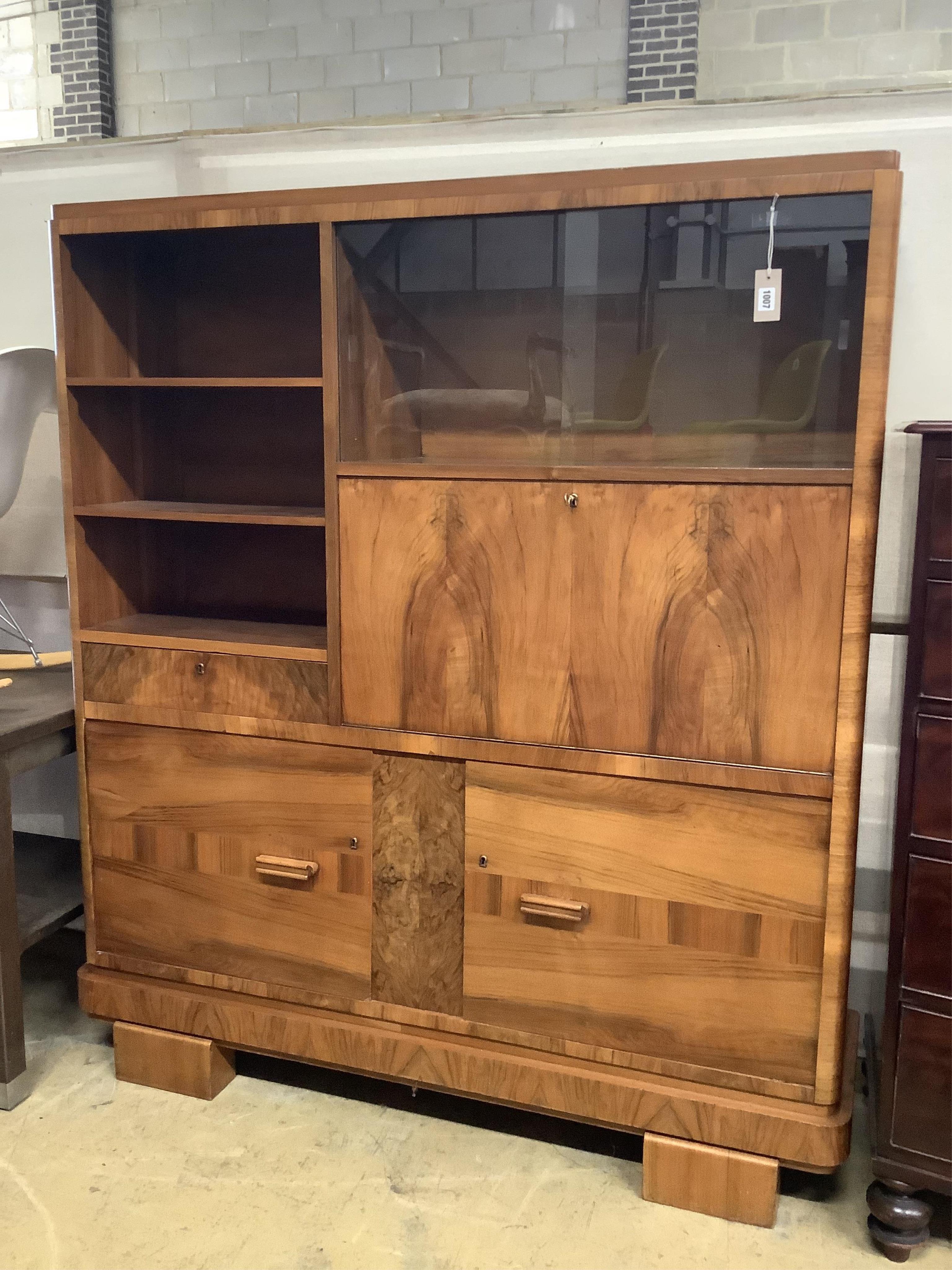 An Art Deco German walnut bureau cabinet, width 138cm, depth 37cm, height 160cm